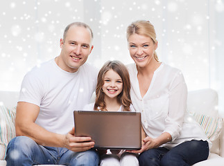 Image showing smiling family with laptop at home