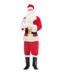 Image showing man in costume of santa claus with clock