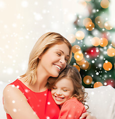 Image showing happy mother and daughter hugging at home