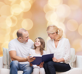 Image showing happy family with book at home