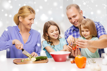 Image showing happy family with two kids making dinner at home