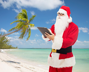 Image showing man in costume of santa claus with tablet pc