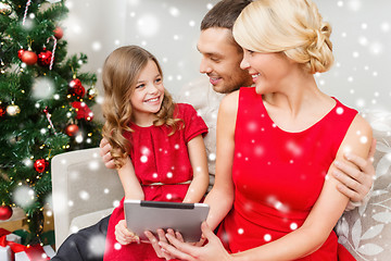 Image showing smiling family with tablet pc at home