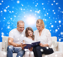 Image showing happy family with book at home