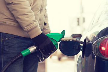 Image showing close up of male refilling car fuel tank