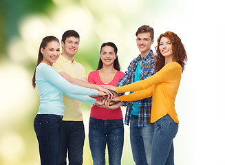 Image showing group of smiling teenagers over green background