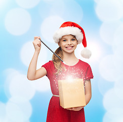 Image showing smiling girl in santa helper hat with gift box