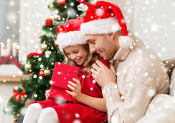 Image showing smiling father and daughter holding gift box