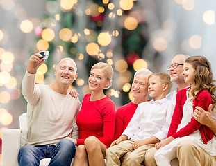 Image showing smiling family with camera