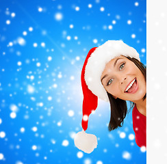 Image showing woman in santa helper hat with blank white board