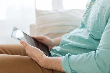 Image showing close up of man with tablet pc computer at home