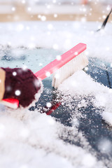 Image showing closeup of woman cleaning snow from car