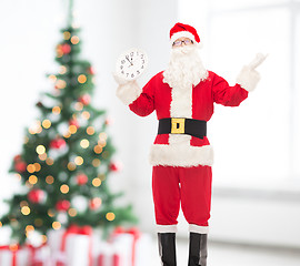 Image showing man in costume of santa claus with clock