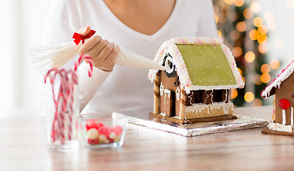 Image showing close up of woman making gingerbread houses