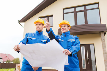 Image showing group of builders with blueprint pointing finger