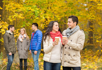 Image showing group of smiling friend with coffee cups in park