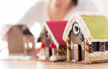 Image showing close up of woman making gingerbread houses