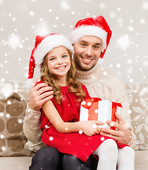 Image showing smiling father and daughter holding gift box