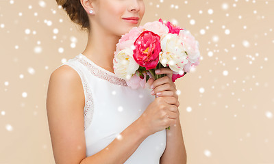 Image showing close up of woman in white dress with flowers