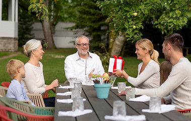 Image showing happy family having holiday dinner outdoors