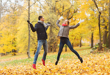 Image showing smiling couple having fun in autumn park