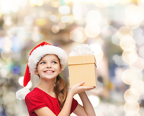 Image showing smiling girl in santa helper hat with gift box