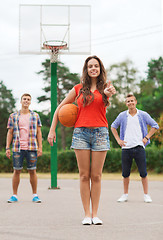 Image showing group of smiling teenagers playing basketball