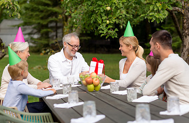 Image showing happy family having holiday dinner outdoors