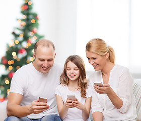 Image showing happy family with smartphones
