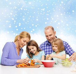 Image showing happy family with two kids making dinner at home