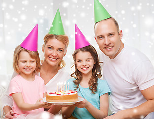 Image showing happy family with two kids in party hats at home