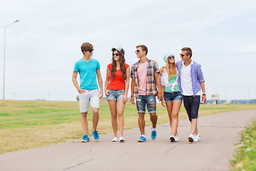 Image showing group of smiling teenagers walking outdoors