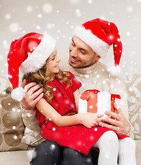 Image showing smiling father and daughter holding gift box