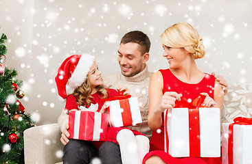 Image showing smiling family holding many gift boxes