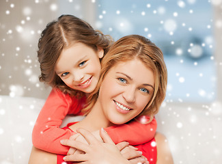 Image showing happy mother and daughter hugging at home