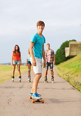 Image showing group of smiling teenagers with roller-skates