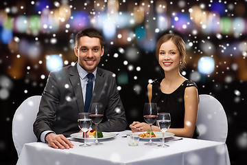 Image showing smiling couple eating main course at restaurant