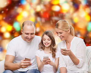 Image showing happy family with smartphones