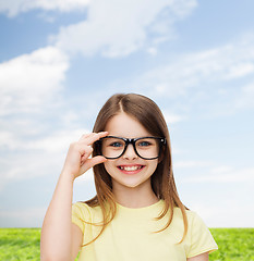 Image showing smiling cute little girl in black eyeglasses