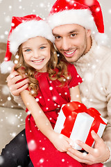 Image showing smiling father and daughter holding gift box