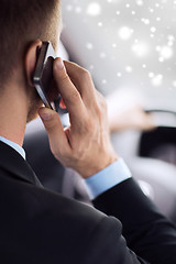 Image showing close up of man using smartphone while driving car