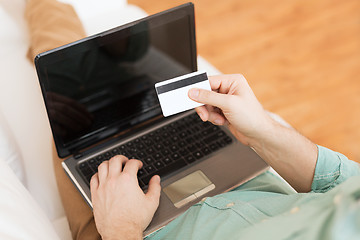 Image showing close up of man with laptop and credit card