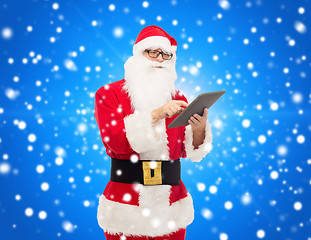 Image showing man in costume of santa claus with tablet pc