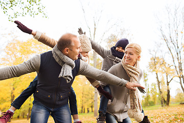 Image showing happy family having fun in autumn park