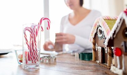 Image showing close up of woman making gingerbread houses