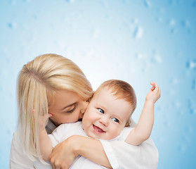 Image showing happy mother kissing smiling baby