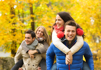 Image showing smiling friends having fun in autumn park