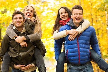 Image showing smiling friends having fun in autumn park