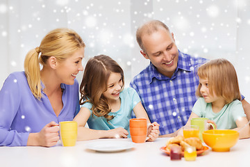 Image showing happy family with two kids having breakfast