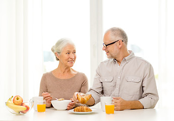 Image showing happy senior couple having breakfast at home